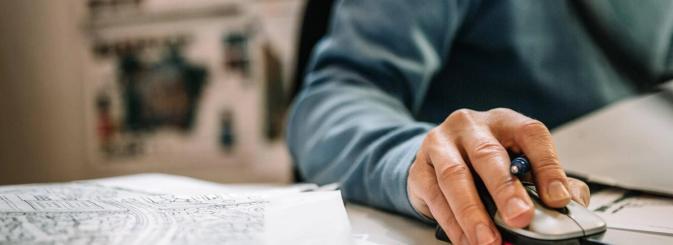 Planner working on a computer with detailed site plans