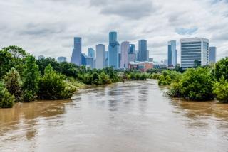 Wide river flowing towards a city