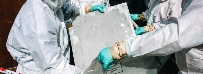 People in hazmat suits dealing with asbestos