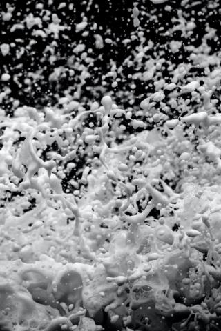 Foam splashing on a black background