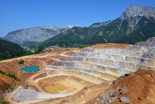 Open mine pit with mountains in background