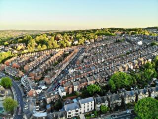 aerial view of a residential development in the UK, surrounded by trees
