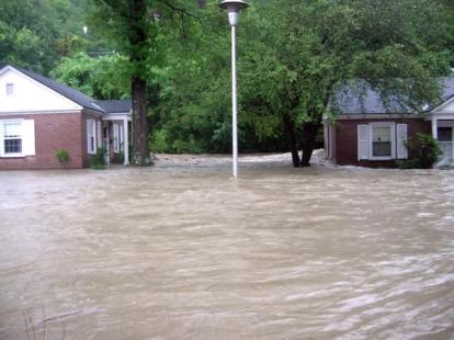Water jumped river bank and travelled behind and between buildings