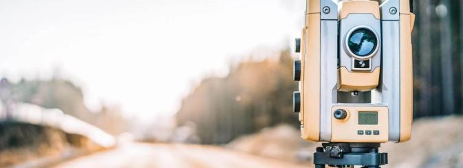 Land surveying equipment set up near road